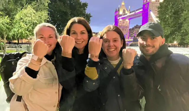 Jessica Cooper, Anna Coward, Rochelle Pearson and Frazer Seabright show off their wristbands after joining the queue on Sunday night