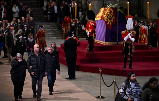 Members of the public queue to pay their respects