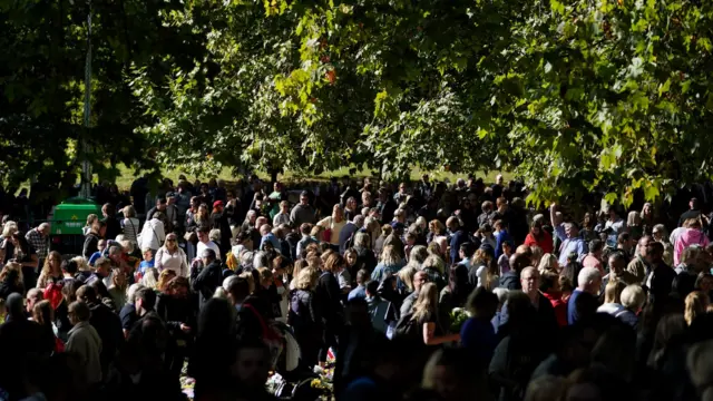 Members of the public place flowers in green park following the death of Queen Elizabeth II. Picture date: Sunday September 18, 2022.