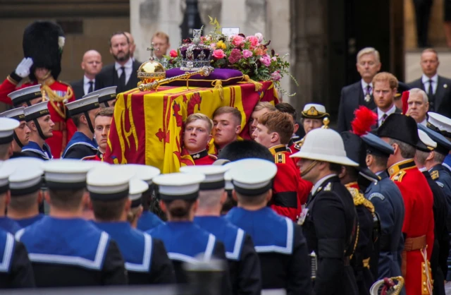 The coffin of Queen Elizabeth II is placed on a gun carriage during her funeral service in Westminster Abbey