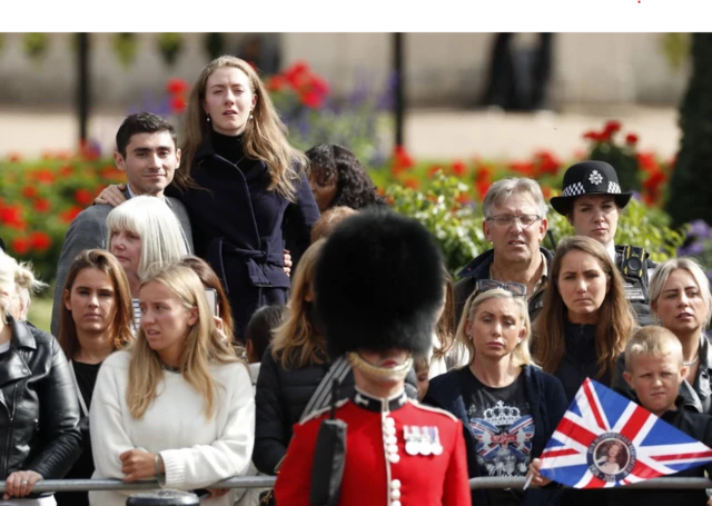 Crowds watch on as procession carries queen's coffin