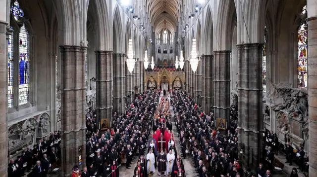 The procession makes its way through the church