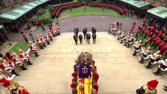 Coffin is carried into chapel