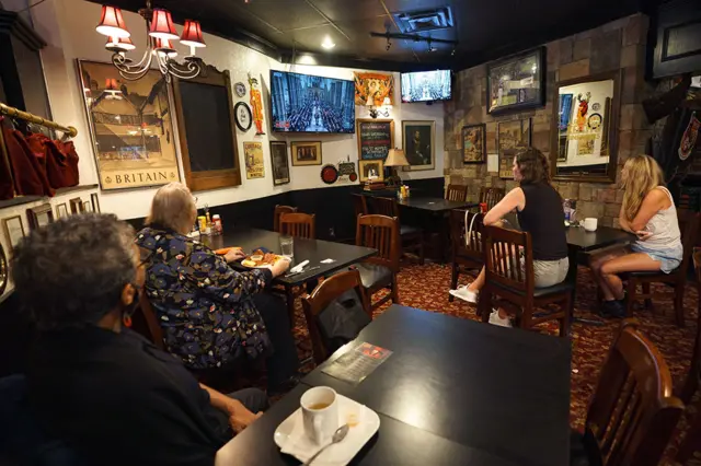 People watch the funeral in a pub in Toronto, Canada