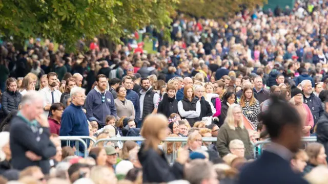 People watch the funeral of Queen Elizabeth II on a big screen