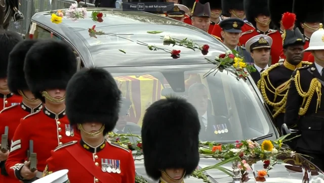 Soldiers march alongside Queen's coffin