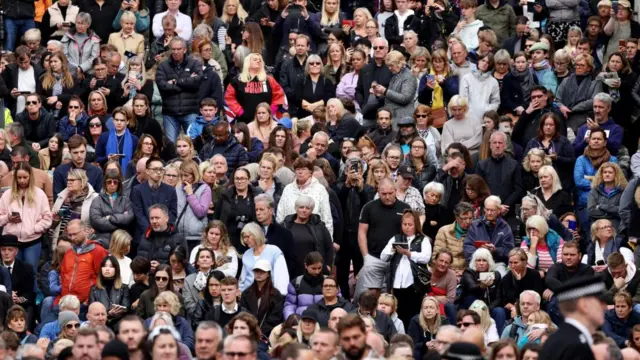 People stand on The Mall