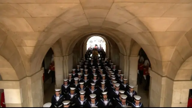 Procession passes through arch into Horse Guards Parade