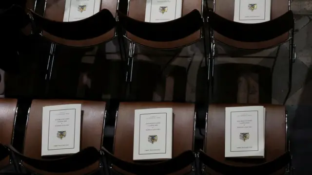 Funeral programs are left on chairs