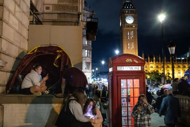 People camp out in a tent by Westminster and Big Ben ahead of the Queen's funeral.