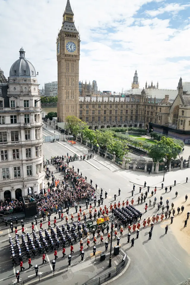 The procession passes the Houses of Parliament