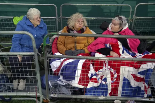 Members of the public set up chairs next to barriers on the procession route along the Long Walk in Windsor, Berkshire, ahead of the funeral of Queen Elizabeth II, on 18 September 2022