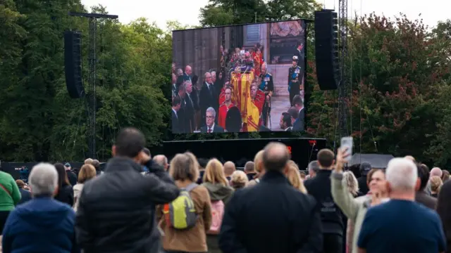 People watch the State Funeral of Queen Elizabeth II on the screen in Hyde Park London, Britain, 19 September 2022