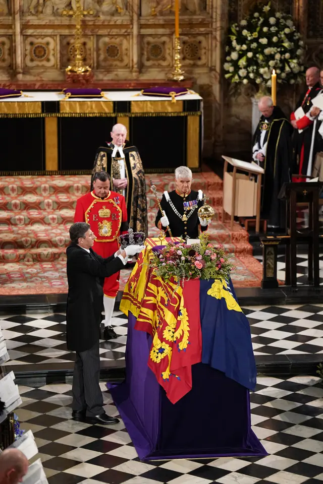 The Imperial State Crown is removed from the coffin