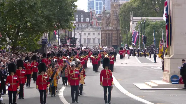 The procession makes its way through Whitehall