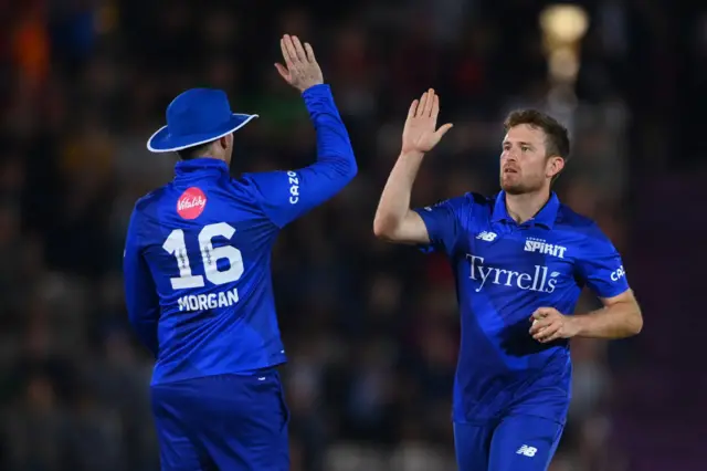 Eoin Morgan and Liam Dawson high-five after taking a wicket for London Spirit