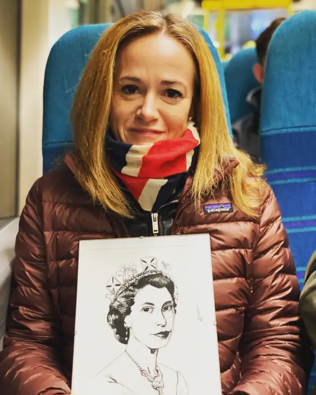 Frances King shows the portrait of the Queen drawn by her son