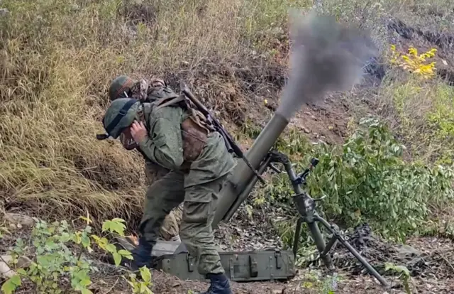 self-proclaimed Donetsk People's Republic (DPR) firing with a mortar