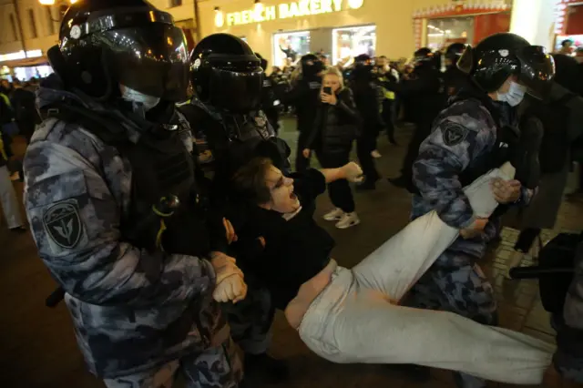 Russian police officers detain a protester during an anti-war rally at Arbat street, Moscow