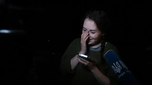 Kateryna Polishchuk, who was captured by Russian forces after being one of the Ukrainian defenders of the Azovstal steel works in Mariupol, reacts as she speaks on the phone following the exchange