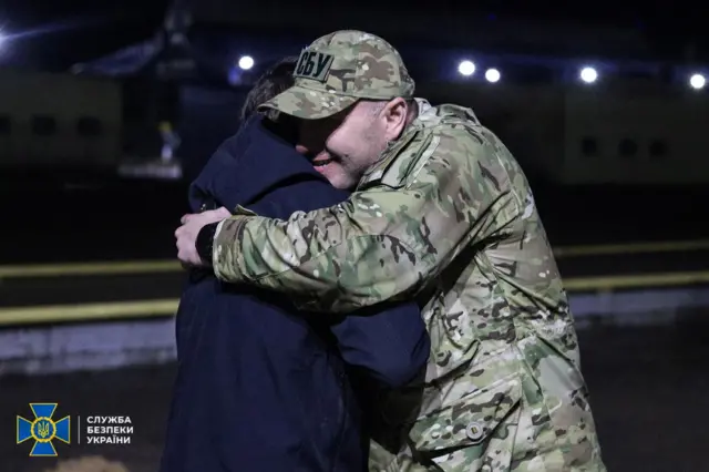 Head of the Ukraine's State Security Service Vasyl Maliuk embraces a prisoner of war after a swap took place in Chernihiv region of Ukraine