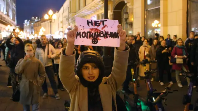 An activist participates in an unsanctioned protest at Arbat Street September 21, 2022 in Moscow, Russia. The sign plays on the word mobilization as "No burialization." More than 500 people in Russian cities today were detained during rallies against President Putin's mobilization of military reservists for the war against Ukraine