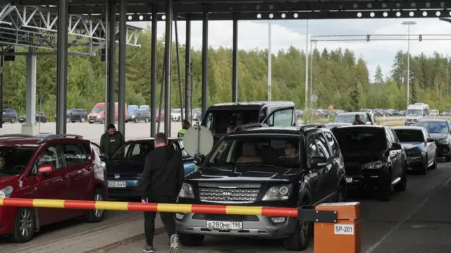 Cars queue to enter Finland from Russia at Finland's most southern crossing point Vaalimaa