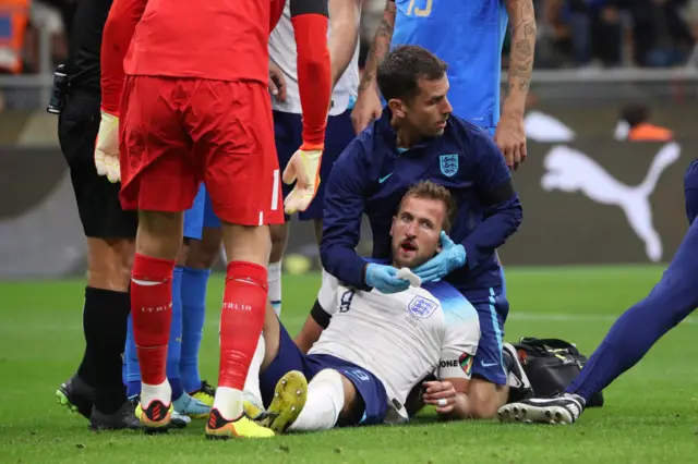 Harry Kane of England is attended to by medical staff