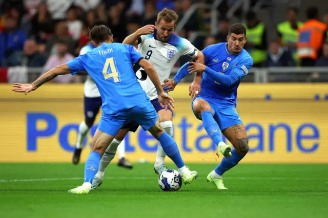 Harry Kane of England is challenged by Rafael Toloi