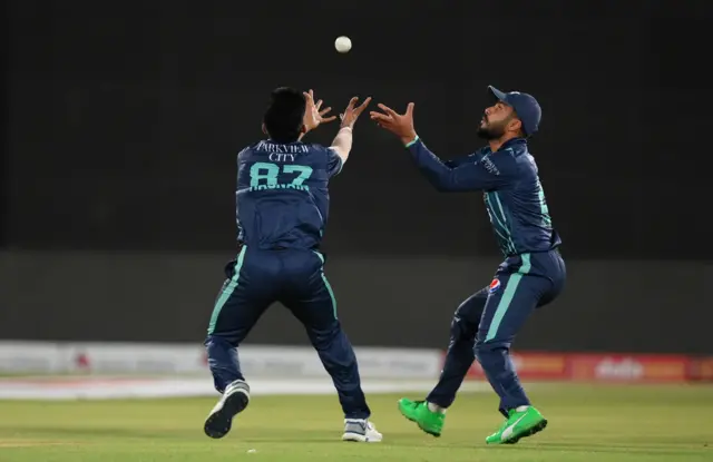 Mohammad Nawaz (right) of Pakistan catches out Phil Salt of England alongside Mohammad Hasnain (left)