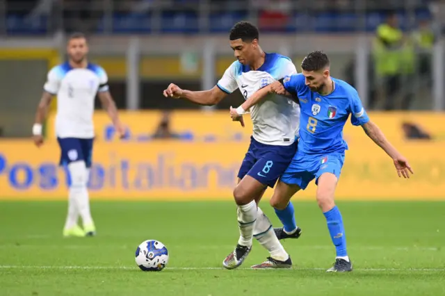 Jude Bellingham of England is challenged by Jorginho