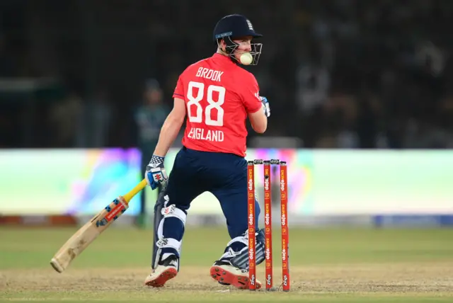 England batter Harry Brook with the ball stuck in the grille of his helmet