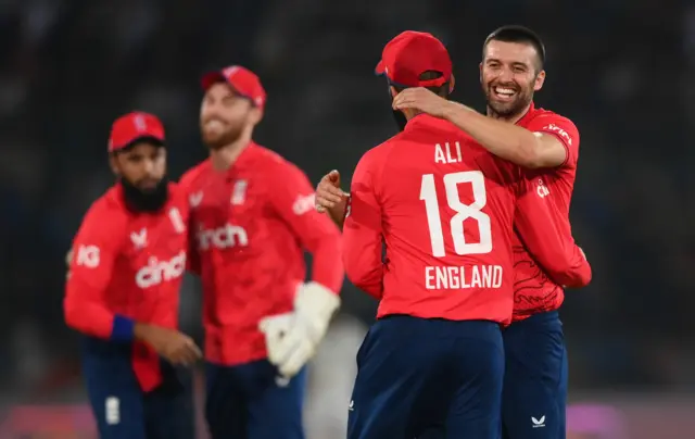 Mark Wood celebrates with Moeen Ali in T20I in Karachi