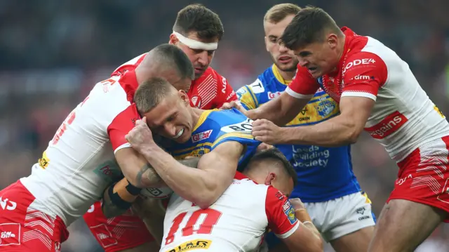 Leeds' Mikolaj Oledzki is tackled by four St Helens players