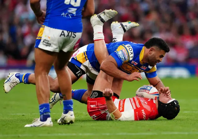 St Helens' Jonny Lomax (right) is tackled by Leeds' Rhyse Martin