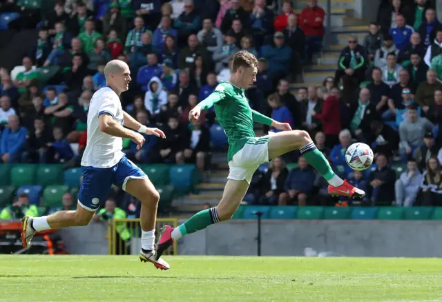 Conor Bradley is first to the ball in June's draw with Cyprus at Windsor Park