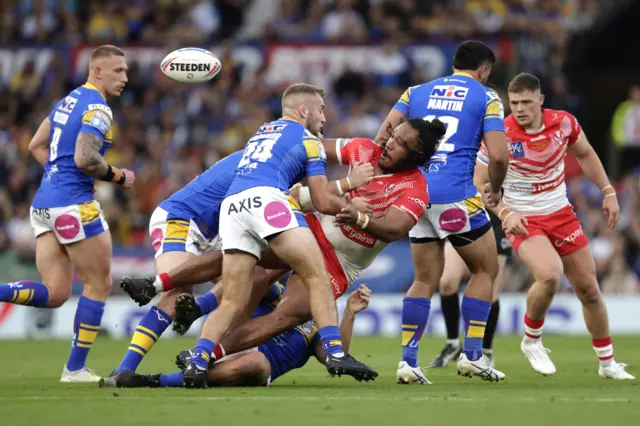 St Helens' Agnatius Paasi is tackled by Leeds Rhinos' Jarrod O'Connor (second left)