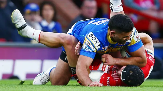 Rhyse Martin tackles Jonny Lomax and dumps him on his back