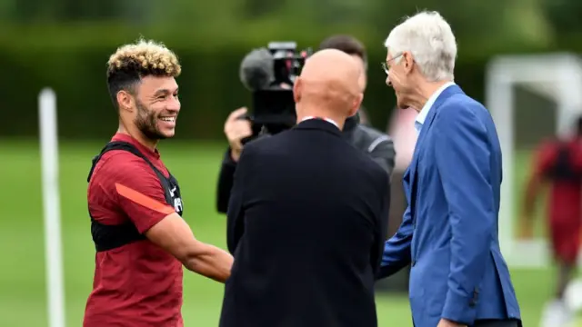 Arsene Wenger meets Liverpool's Alex Oxlade-Chamberlain