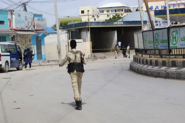 Somali security officials gather at the scene of an attack, outside the Hayat Hotel in Mogadishu, Somalia, 20 August 2022