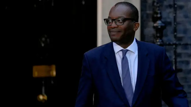 Chancellor Kwasi Kwarteng walks outside 10 Downing Street in London