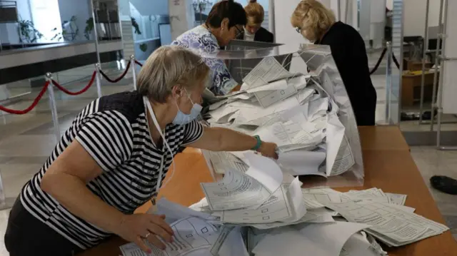 A ballot box is emptied in Russian-occupied Crimea, following votes in a so-called referendum over the status of Ukraine's eastern Donetsk region