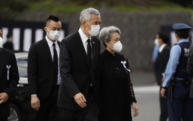 Singapore's Prime Minister Lee Hsien Loong and his wife arrive at the funeral ceremony