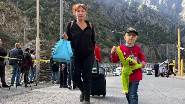 Civilians crossing the Upper Larsi border crossing between Russia and Georgia.