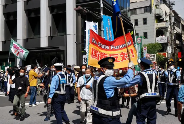 Protesters hold a banner against the state funeral of former Japanese prime minister Shinzo Abe outside the Nippon Budokan in Tokyo on September 27, 2022.