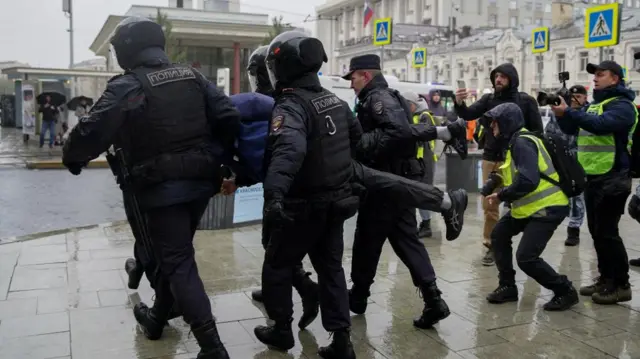 Russian law enforcement officers detain a person during a rally in Moscow, Russia, on 24 September 2022.