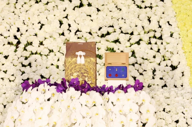 Mr Abe's ashes in a ceremonial bag and his honours in a box in the middle of the shrine