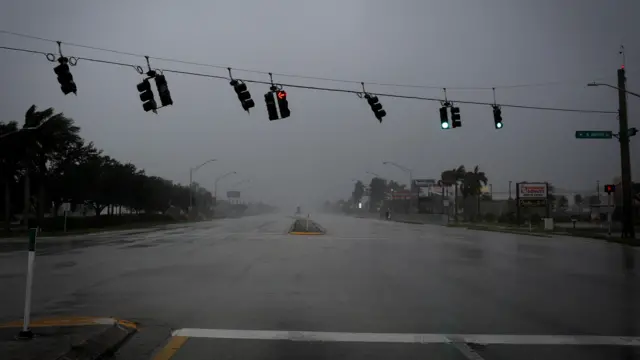 Traffic lights wave by strong gust of wind ahead of Hurricane Ian, in Fort Myers, Florida,