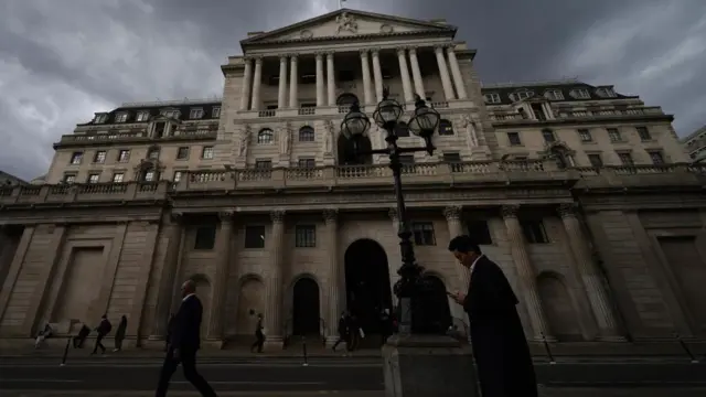 Exterior view of the Bank of England with a cloudy sky behind