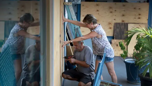 Frederic and Mary Herodet board up their restaurant on St Petersburg Beach